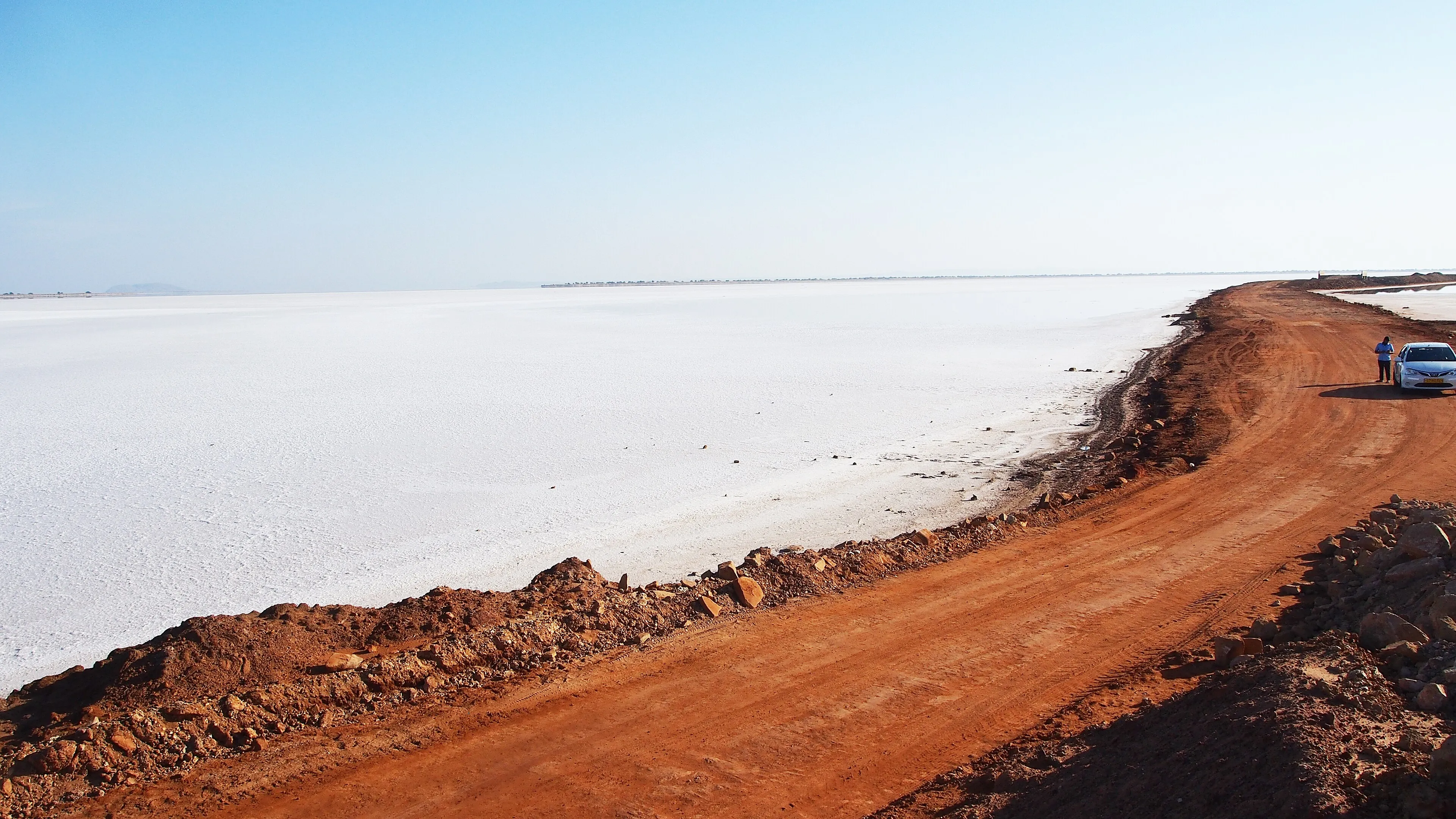 A car on the open desert road toward the Rann of Kutch near Bhuj